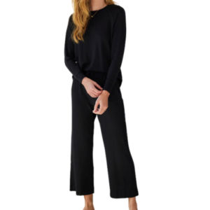 A woman wearing a black top and pants set